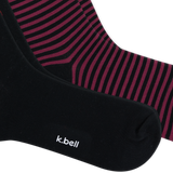Close-up of two pairs of socks, with one sock in solid black showing the white 'k.bell' logo and the other showing a black and dark pink striped pattern. thumbnail