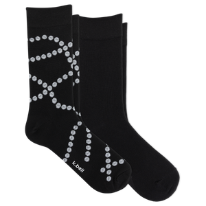 Two black crew socks with a white dotted pearl pattern, displayed on a clean white background. The brand name 'k-bell' is printed in white near the toe of the front sock.