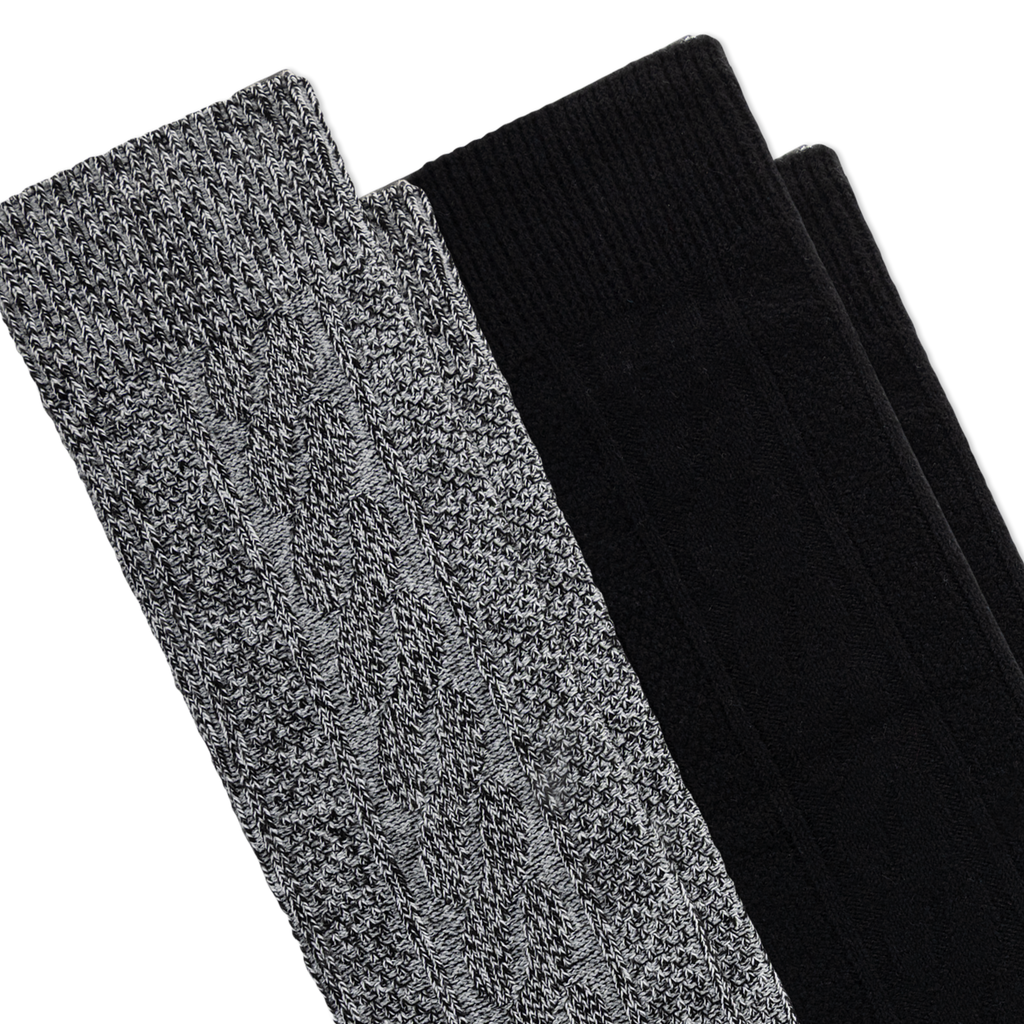 Two pairs of knit boot socks stacked diagonally on a white background, showing a heathered gray-and-black marled texture on the front pair and solid black on the rear pair.