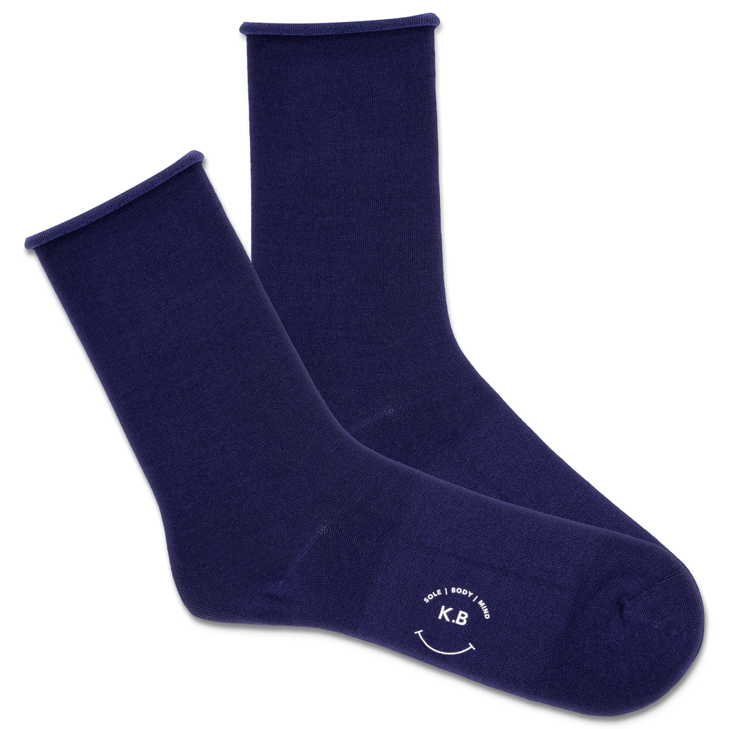 Pair of navy blue roll top socks with a k.bell logo on a white background