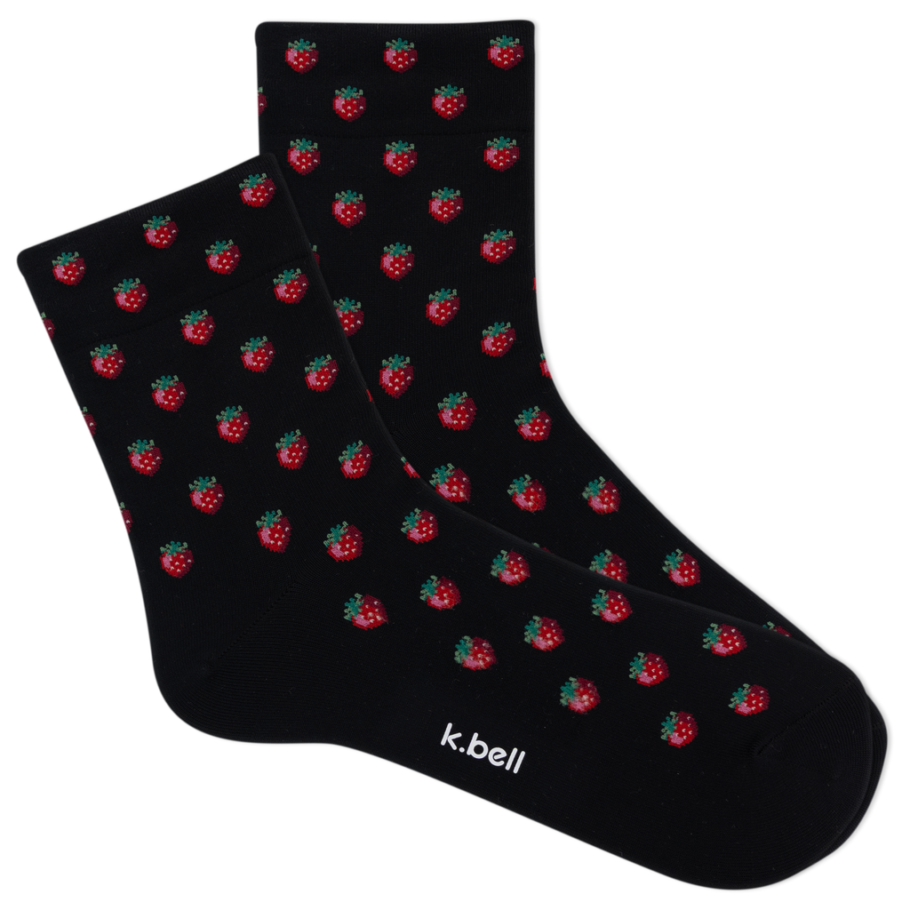 Black socks with red strawberry pattern and 'k.bell' branding on a white background