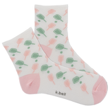Pair of socks with a pattern of green and pink shapes on a white background, featuring the brand 'k.bell'.