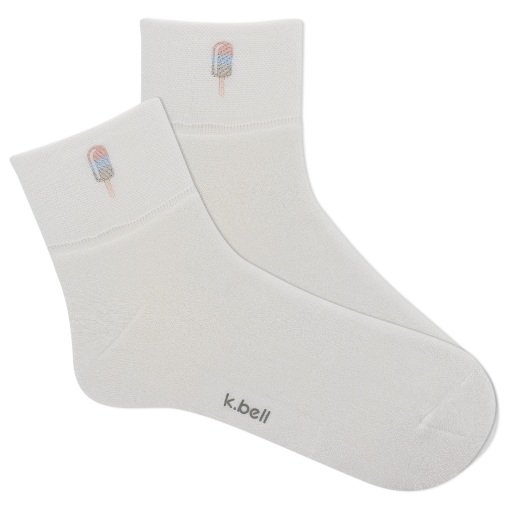 White socks with ice cream cone design and 'k.bell' branding on a white background