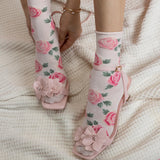 Floral-patterned socks and sandals on a textured surface