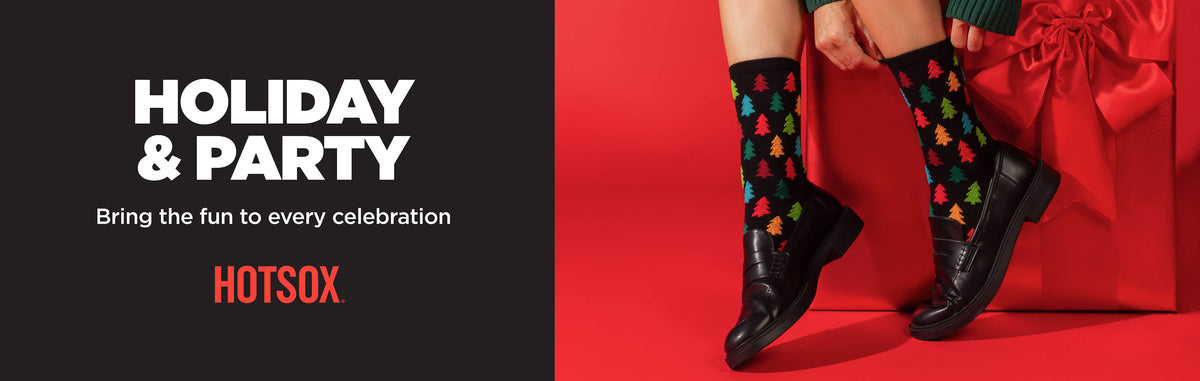 A promotional banner for HOTSOX featuring a person wearing black dress socks with a Christmas tree pattern, paired with black leather shoes, standing next to a red gift bag against a red background. The left side of the banner has a black background with white and orange text reading 'HOLIDAY & PARTY', 'Bring the fun to every celebration', and 'HOTSOX'.