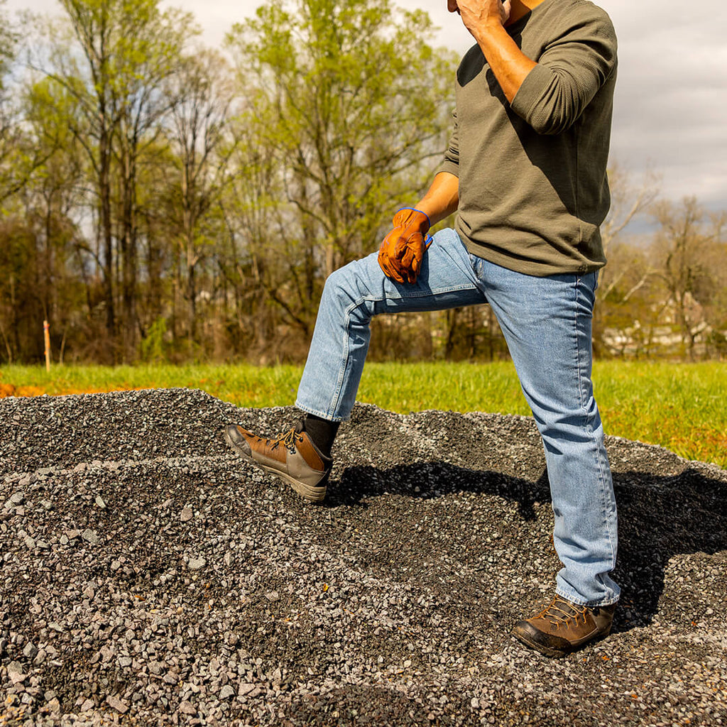 Person sitting on a rock with a natural landscape in the background