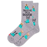 Person wearing white sneakers, gray socks with dog illustrations, and a teal outfit with a stethoscope.