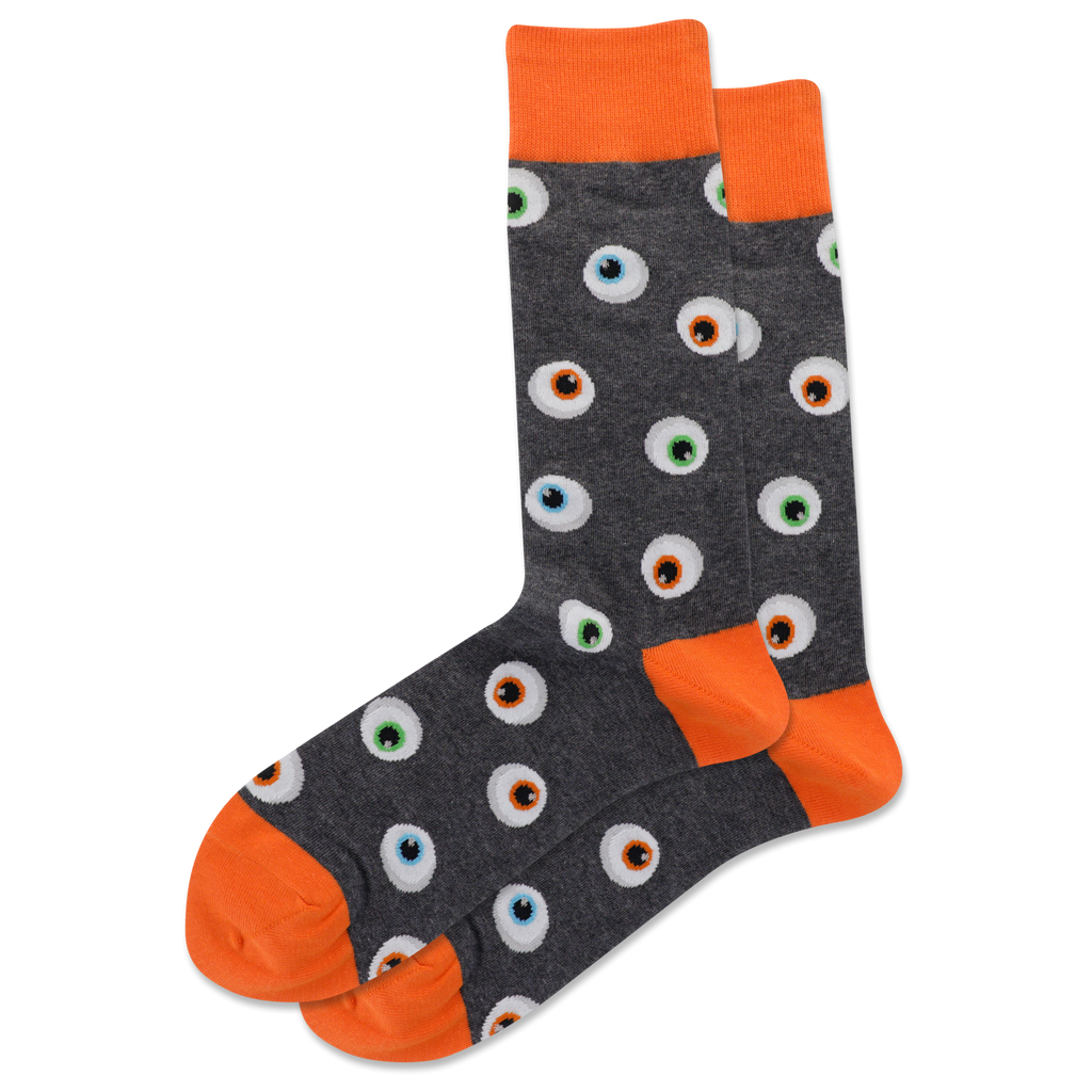 A pair of men's crew socks with a pattern of glowing eyeballs on a dark background and orange trim.