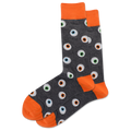 A pair of men's crew socks with a pattern of glowing eyeballs on a dark background and orange trim.