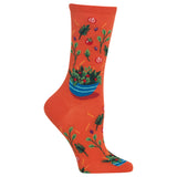 Orange sock with salad bowl and vegetable design on a white background