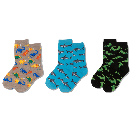 Gray socks with colorful dinosaur pattern worn by a child in denim jeans.