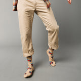 Person wearing beige pants and patterned socks with cars and surf boards on a gray background thumbnail