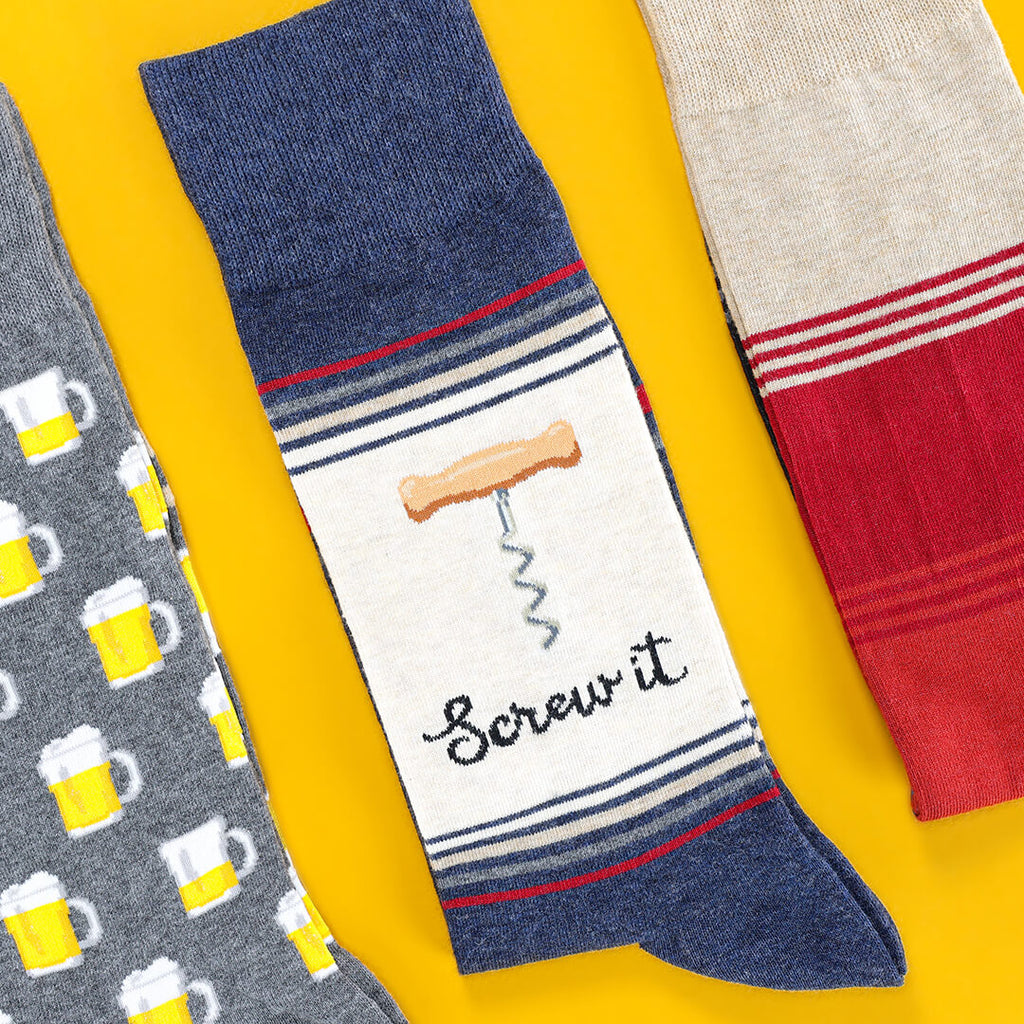 THhree pairs of socks with different alcohol designs on a yellow background