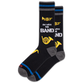 Black socks with musical instrument designs and text on a white background