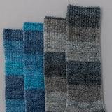 Two pairs of checkered socks in blue and gray on a gray background thumbnail