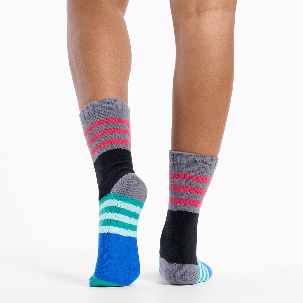 Colorful striped socks worn by a person on a white background