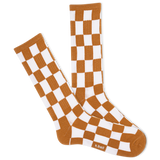 Man on  court wearing orange-brown checkered crew socks in slides and tan shorts.