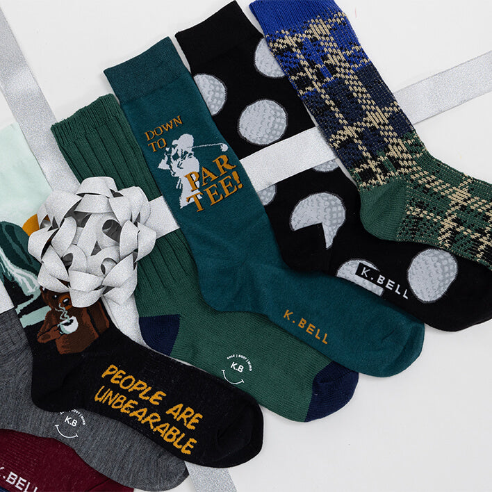 Collection of various socks with different designs and text on a white background