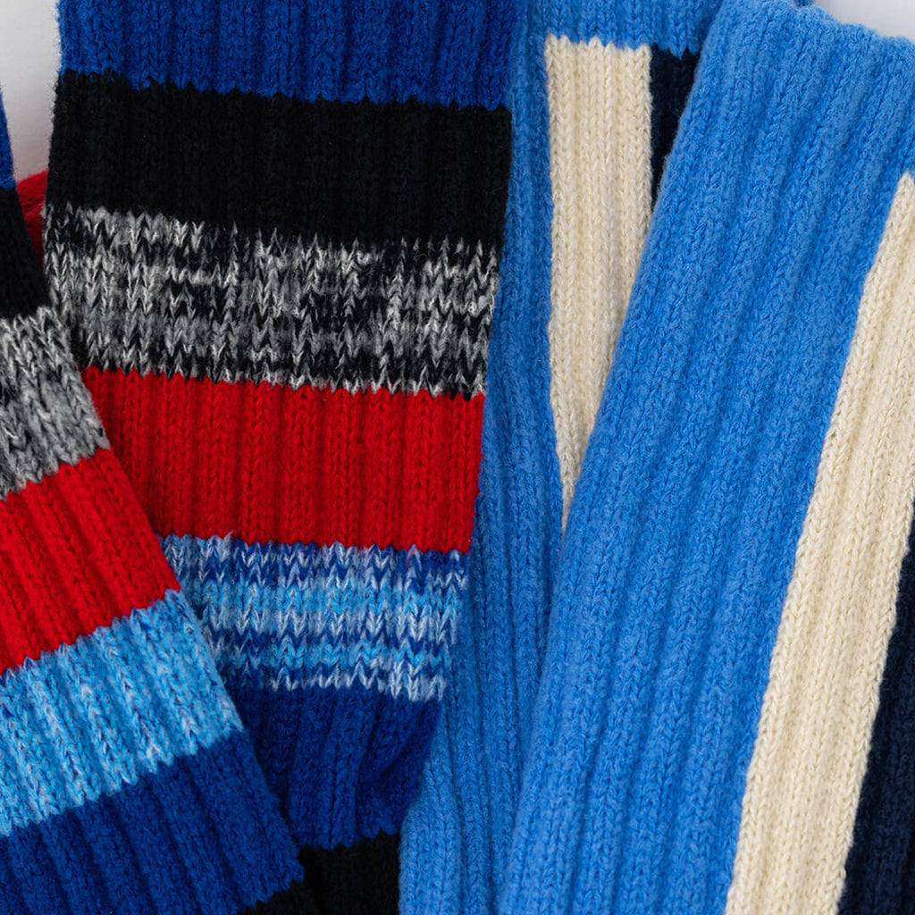 Close-up of a colorful striped sweater with blue, red, and gray patterns.