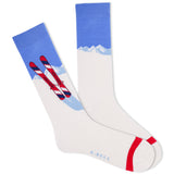 A pair of white crew socks with a blue and red graphic design featuring skis and a mountain range. The brand name 'K.Bell.'