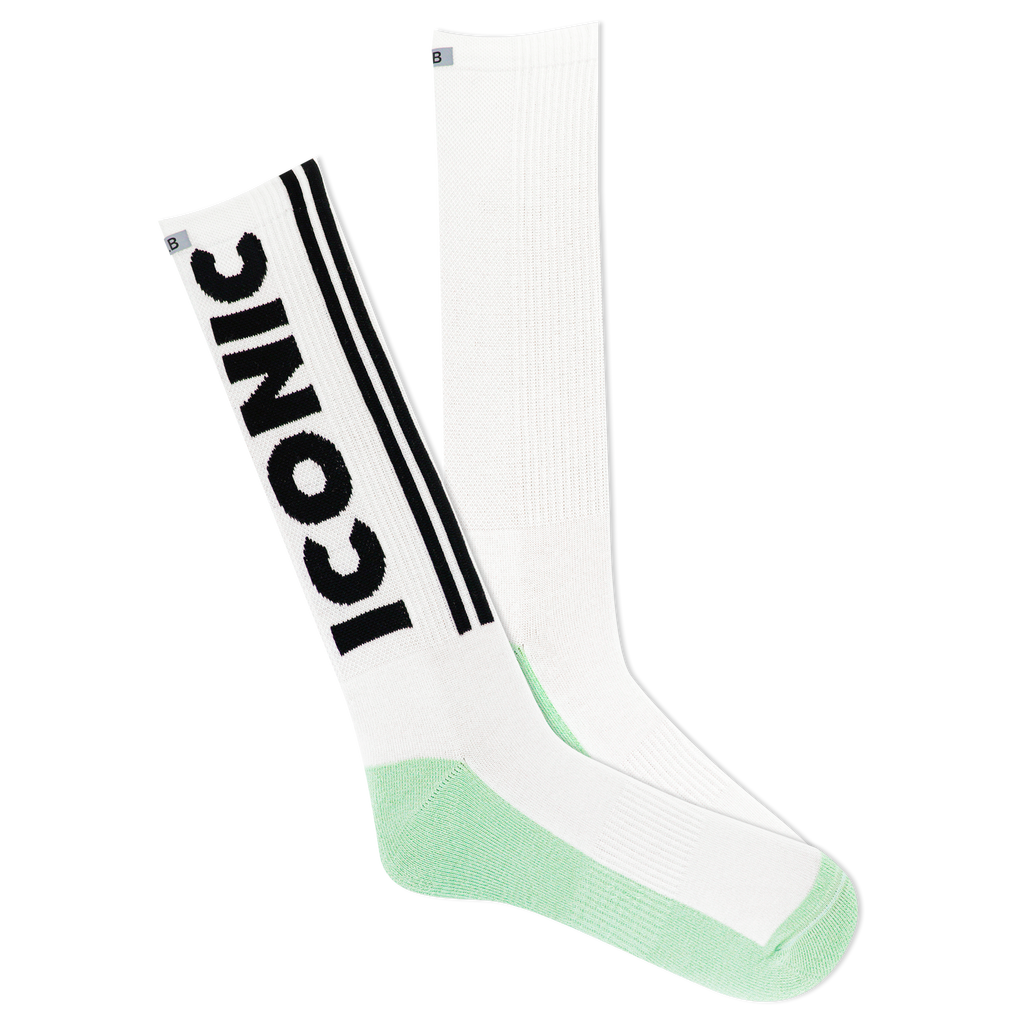 A pair of white crew socks with green accents and the text 'ICONIC' printed on the side, featuring a reflective logo.