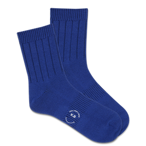 Pair of blue socks with a K.Bell logo on a white background