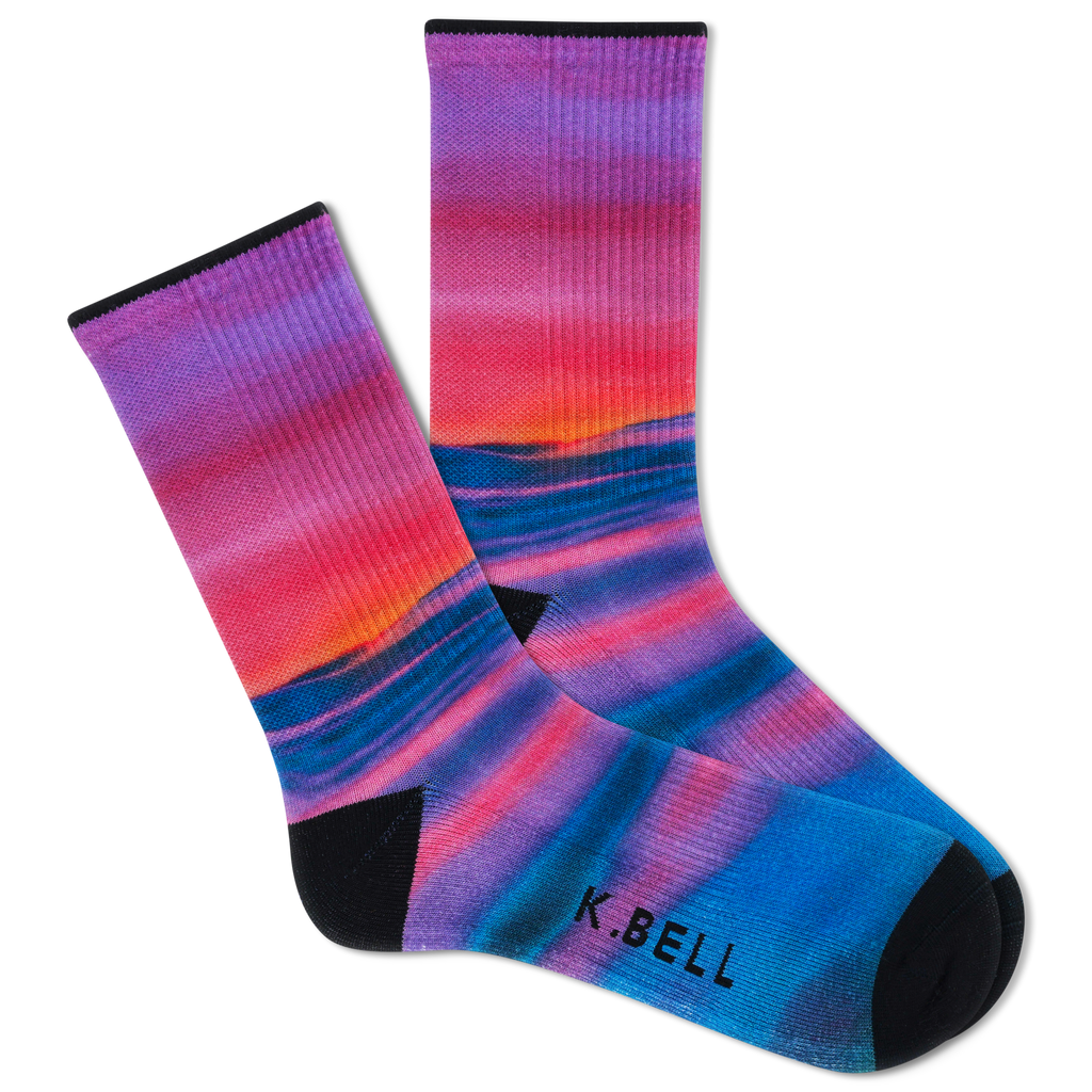 Two people wearing matching outfits with colorful socks in a casual setting.