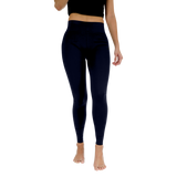 Person wearing navy leggings on a white background