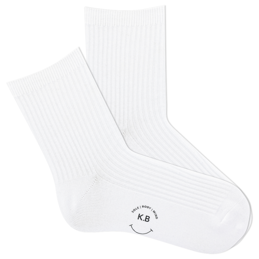 White ribbed women's socks with a smiley face and 'KB' logo on a white background