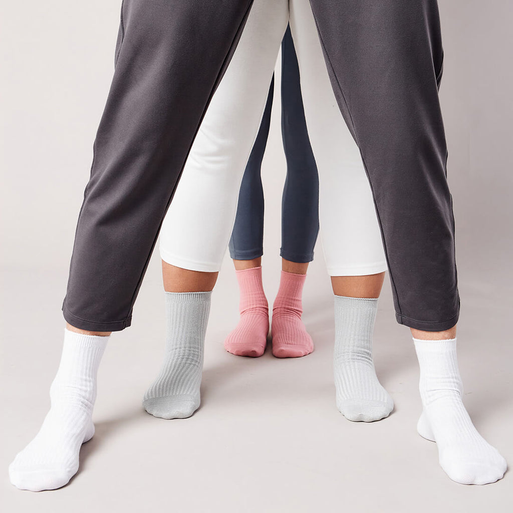 Three pairs of pants worn by different people on a plain background