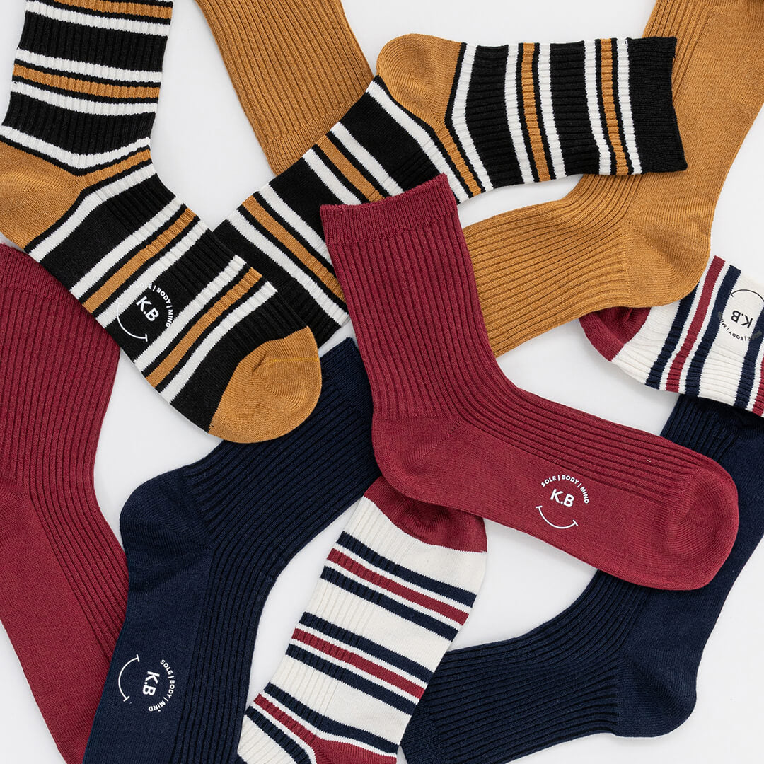 Collection of various patterned socks with a brand logo on a white background