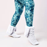 Blue tie-dye leggings with white fuzzy socks on a light pink background thumbnail