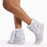 Gray fuzzy socks worn by a person on a white background thumbnail