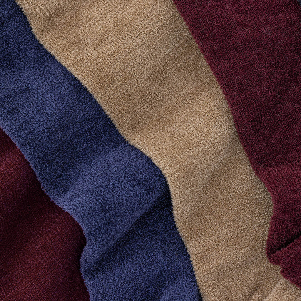 Close-up of blue, beige, and red velvet socks.