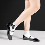 Black shoes with white ankle socks decorated with a giant black bow and black shoes on a white background. thumbnail