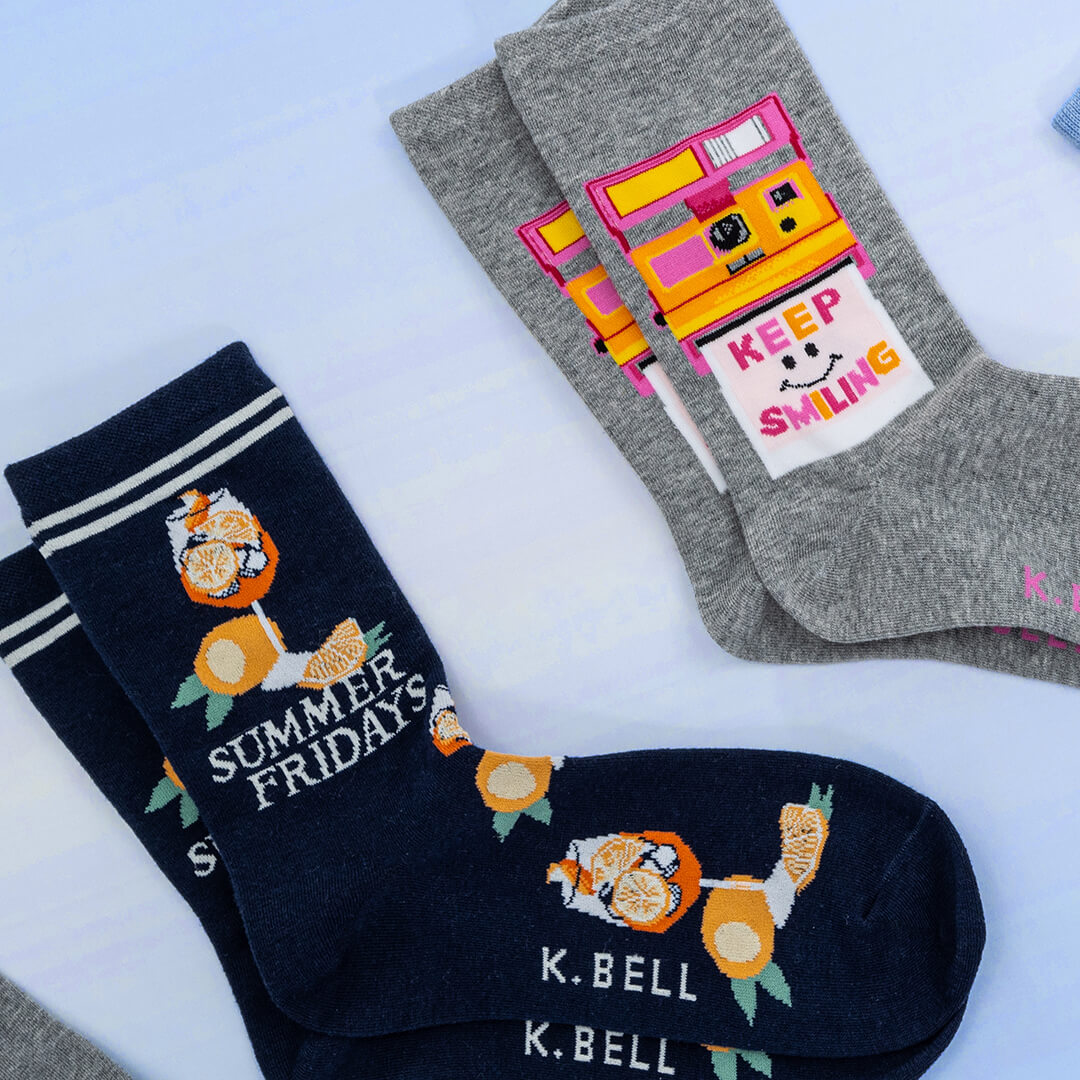 Two pairs of socks with designs and text on a light background