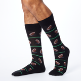 Front view of HOTSOX men's black crew socks on model with a repeat football pattern.